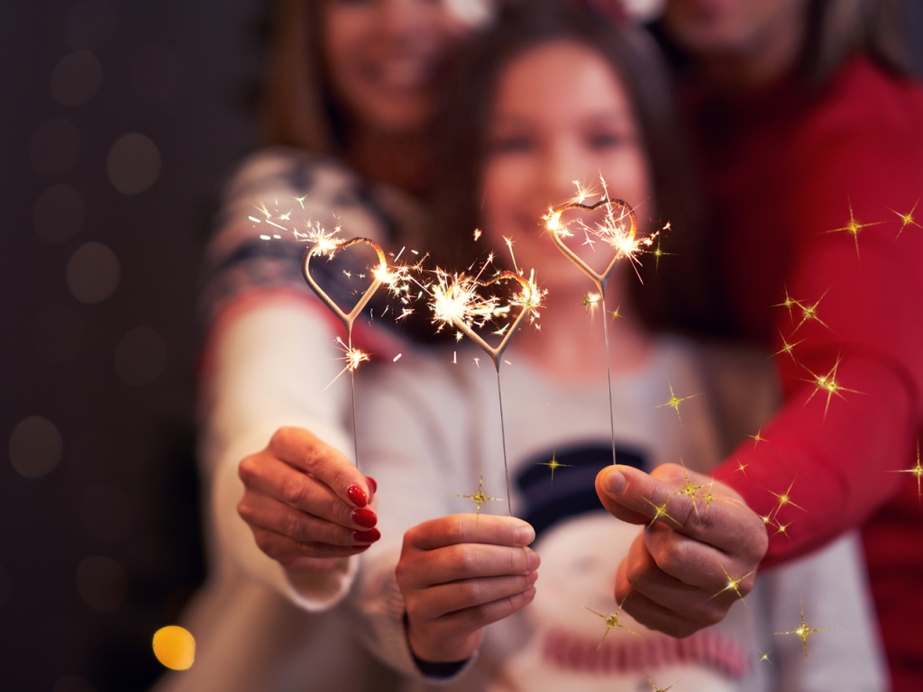 image shows a family holding sparklers