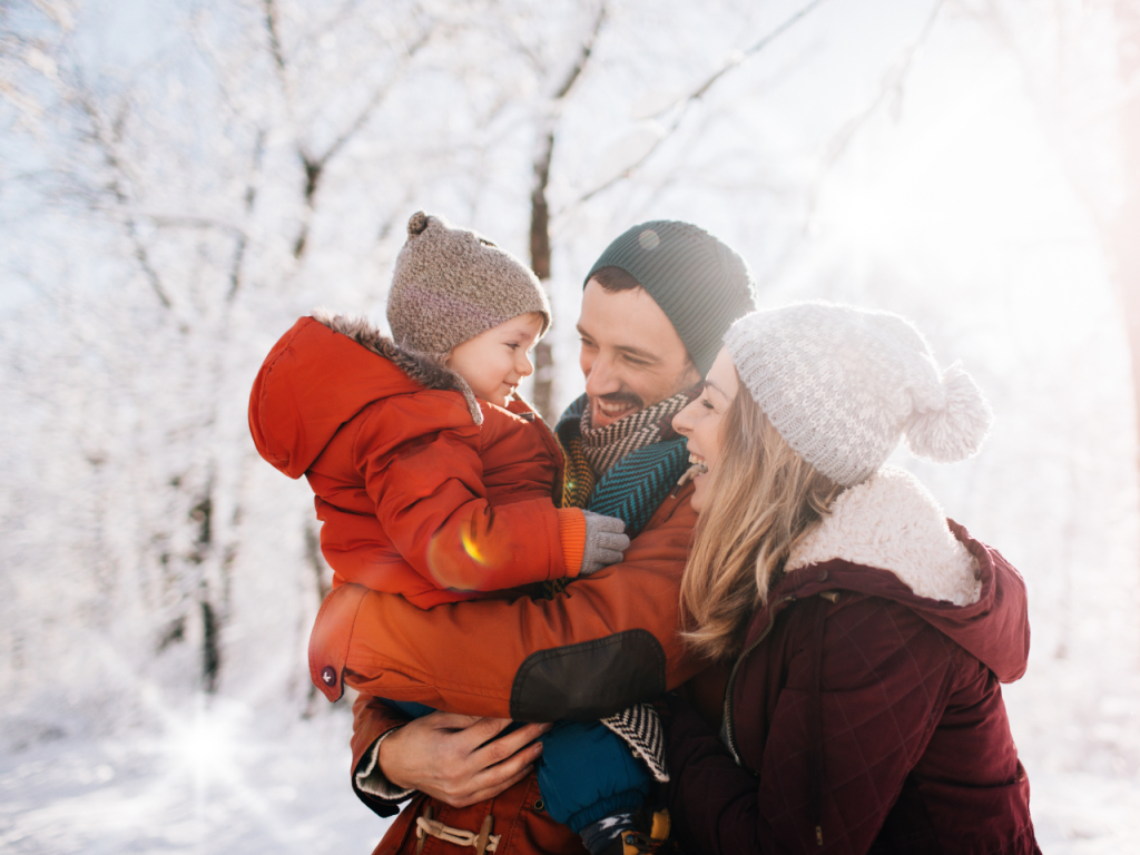 image shows family spending time together outside during the winter